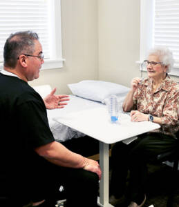 physical therapist consulting with patient