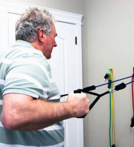 physical therapy patient using strength bands